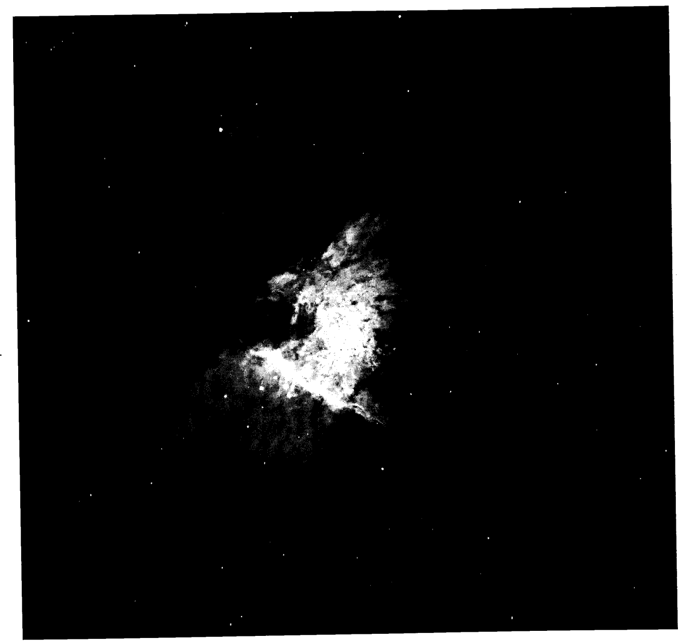 NGC 1976, the Orion Nebula, probably the most-studied H II region in the sky. The contrast in this image, which was taken in the light of Hα , has been reduced to allow both the bright inner regions and the faint outer regions to be visible. The Trapezium is the group of four stars near the center of the nebula. The nebula to the upper left (northeast) is NGC 1982. ( John Bally, KPNO )